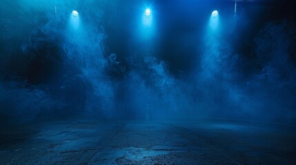 Blue spotlights illuminate an empty stage covered in smoke