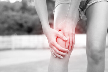 female touching painful twisted or broken ankle. Athlete training accident. Sport sprain cause...