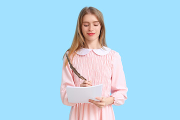 Female author with feather and paper sheets on blue background