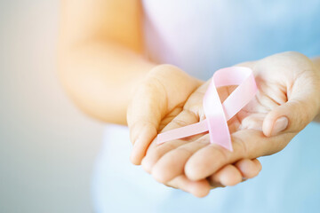 woman with Pink ribbon for patients with breast and cervical cancer