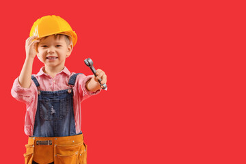 Cute little builder with toy wrench on red background - obrazy, fototapety, plakaty
