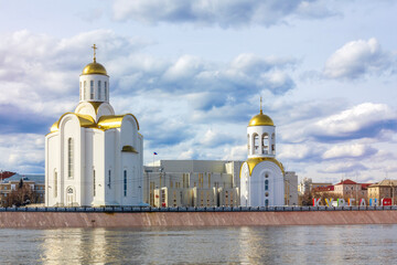 The view of the Tobol River and Holy Trinity Church in Kurgan, Russia.