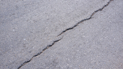 Two crack lines texture on surface of the old asphalt road background in diagonal view, top view...