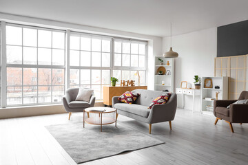 Interior of modern living room with grey armchair, sofa and table
