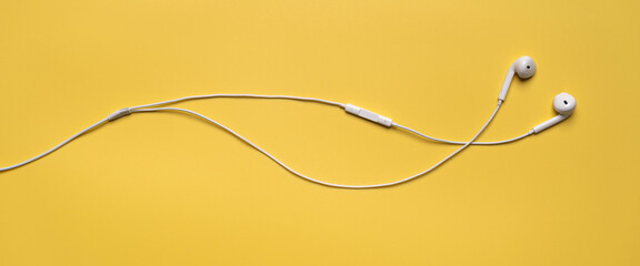 white earphone on yellow background