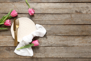 Table setting with tulips on wooden background. Mother's day concept
