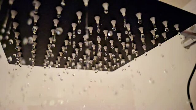 Water coming out of a shower head in slow motion