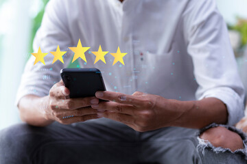 Customer pressing on smartphone with five star icon for feedback review satisfaction service