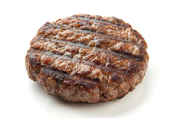 Grilled hamburger patty isolated on a white background
