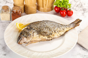 Baked Dorado fish served lemon