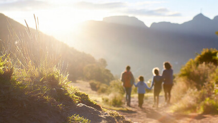 family hiking in the mountains at sunset