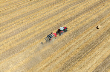 Farm field, farmers work with tractor on farmland,