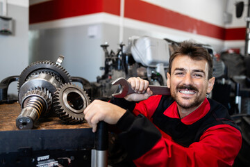 Portrait of smiling serviceman or mechanic with tools.