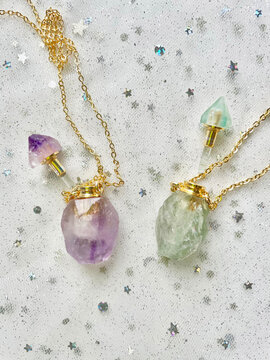 aromatic pendants made of amethyst and green quartz. crystals for healing. aesthetic photo