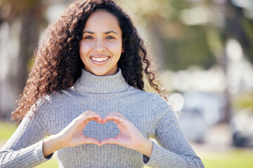 Portrait, heart sign and woman in park, support and outdoor with symbol for love, promotion and...
