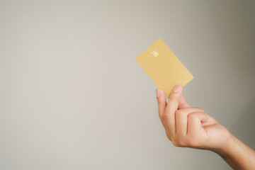 male hand holding gold Bank credit Card mockup template on isolated background