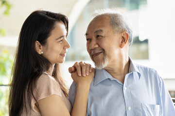Senior Father and Middle aged Daughter, Happy Asian family with daughter hugging old father smiling together in positive expression, concept of Happy Father’s Day, Family Reunion and Togetherness