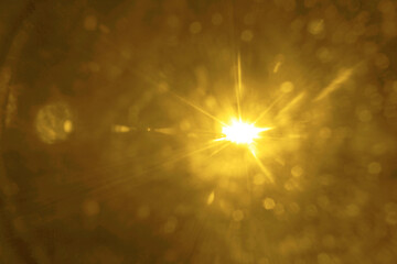 shiny sun, sunbeams, sunrays, sunshine design. yellow, orange  light effect, sun rays, golden beams isolated on black background. star dust. Sun flare on the dark space backdrop