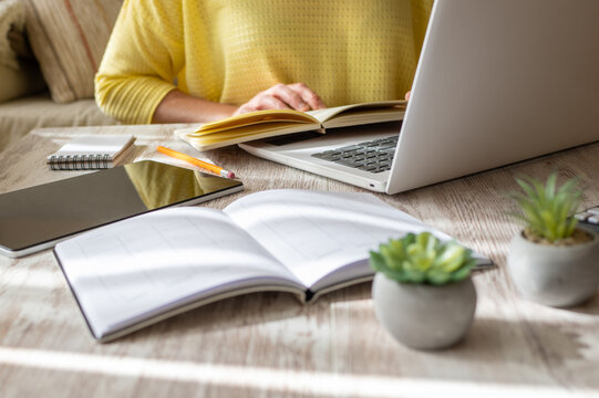Self-Sufficient Person Organizing His Personal Agenda and Scheduling Appointments with New Clients, Uses a Laptop and Agganda. Self-Employed Woman Who Works from Home.