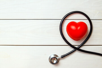 Red heart with stethoscope on white background
