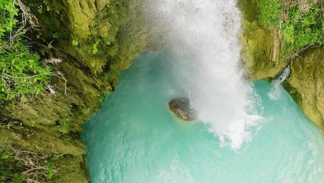 Top view of Beautiful waterfall in green forest in slow motion. Inambakan Falls in slow motion. Cebu, Philippines.