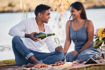 Picnic, happy couple and love with champagne, glass and romantic date for anniversary outdoors. Eye...