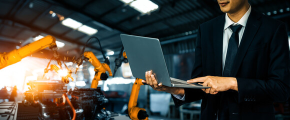 MLB Engineer use advanced robotic software to control industry robot arm in factory. Automation...