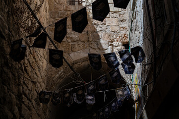 A narrow street among stone houses in old Jerusalem, Israel.