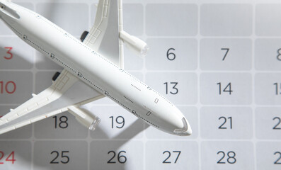 Toy airplane on calendar. Travel