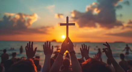 many hands holding cross in the air, beach background with sunset 