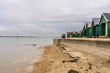 Beach huts at Gurnard Bay on the Solent coast, Isle of Wight, UK