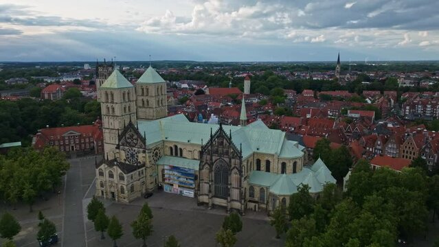 An aerial drone shot of St. Paulus Dom, also known as M&uuml;nster Cathedral, on Domplatz in M&uuml;nster on a sunny day. It is a central and culturally significant area of central M&uuml;nster, Germany. 