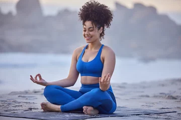 Foto auf Leinwand Yoga, lotus meditation and happy woman at beach for exercise, spiritual fitness or healthy body in summer. Padmasana, ocean and girl in nature for zen, peace and calm mindfulness outdoor for wellness © peopleimages.com