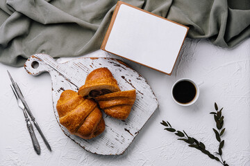 Cozy breakfast setting with croissants and coffee