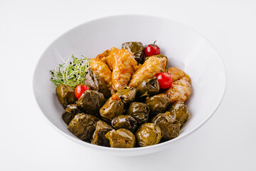 Stuffed grape leaves in white bowl