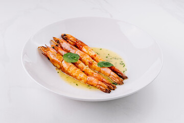 Grilled shrimp with garlic sauce on white plate