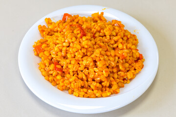 Traditional turkish bulgur pilaf with tomato sause in plate (Turkish name; bulgur pilavi, meyhane pilavi) Pirinc pilavi. Pilavustu tavuk, nohut, kuru fasulye, ciger.