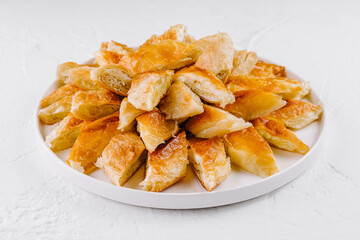 Freshly baked puff pastry bites on plate