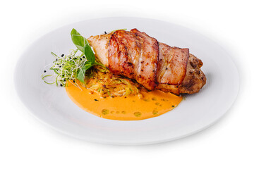 Juicy grilled pork loin on white plate with sauce