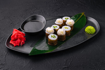 Elegant sushi platter arrangement on dark background