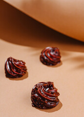 Artistic chocolate swirls on beige background