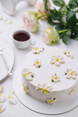 Elegant white floral cake with tea setting