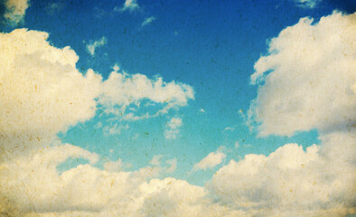 Grunge blue sky and white clouds with vintage effect.