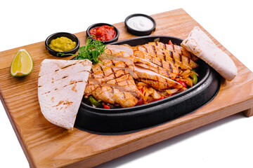 Sizzling chicken fajitas platter with condiments