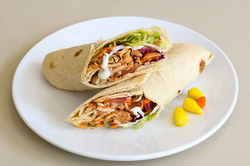 Lavash doner kebab ( zurna et tavuk doner durum )  or shawarma sliced in plate isolated. 