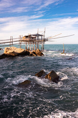 Traditional wooden fishing house with a net near sea coast - 789940115