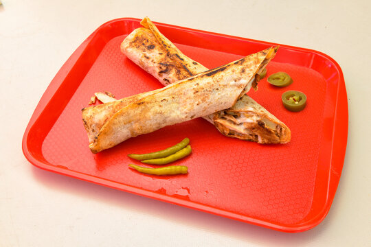 Lavash doner kebab ( zurna et tavuk doner durum )  or shawarma sliced in plate isolated. 