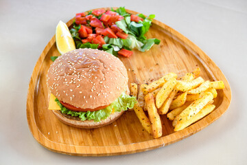 Big tasty burger with beef cutlet on a plate. Hamburger, cheeseburger with mushroom. Crispy chicken burger.