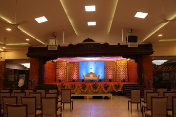 Indian style stage decoration with blue backdrop decorated with lotus flowers and bells