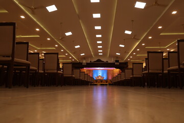 Indian style stage decoration with blue backdrop decorated with lotus flowers and bells
